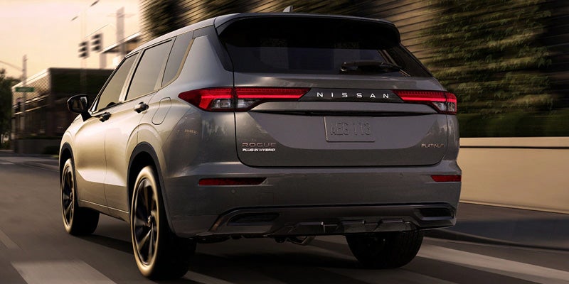 Nissan Rogue gray SUV rear exterior view driving on road
