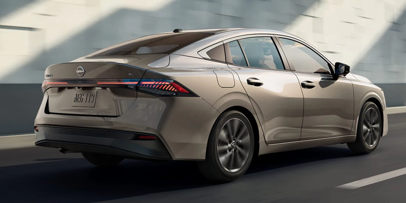 Nissan Sentra gray sedan rear exterior view driving on road